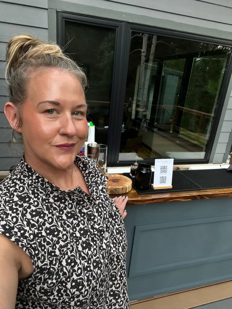Becky taking a selfie in front of the bar at Copper Falls in Loveland